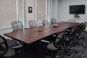 Meeting table in conference room with the shades drawn