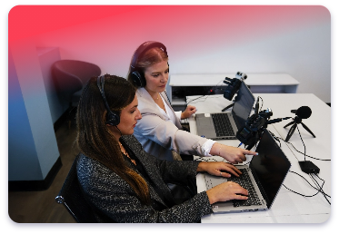 Digital reporter and trainee sit together with equipment set up