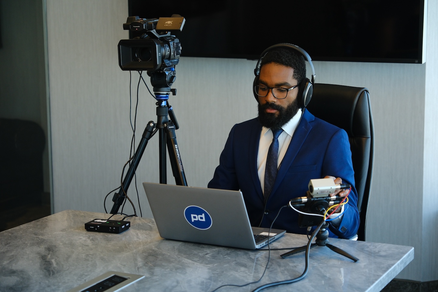 Videographer sits at deposition